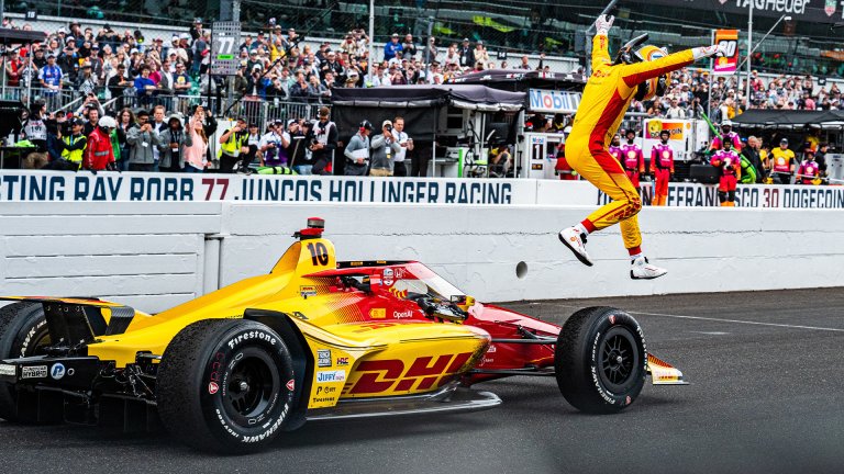 Indianapolis 500 winner Alex Palou leaps from his car after the race.
